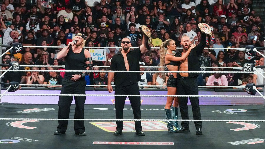 Wrestlers at the end of a match and standing in the ring